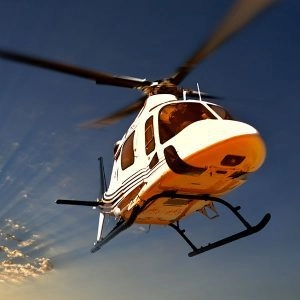 White helicopter in mid air | Airfleet Capital INC